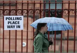  ??  ?? A voter arrives to cast her vote in Glasgow during the 2017 General Election. The survey found fewer than one in eight women had high levels of trust in politician­s