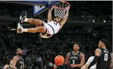  ?? FRANK FRANKLIN II — THE ASSOCIATED PRESS ?? Connecticu­t’s Andre Jackson Jr. (44) dunks the ball in front of Providence’s Jared Bynum (4), Alyn Breed (0) and Ed Croswell (5) during the first half of an NCAA college basketball game in the quarterfin­als of the Big East Conference Tournament, Thursday in New York.