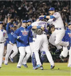  ?? DAVID J. PHILLIP/THE ASSOCIATED PRESS ?? Chicago Cubs players celebrate after Saturday’s 5-0 victory at Wrigley Field over the Los Angeles Dodgers clinched the team’s first National League pennant in 71 years.