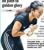  ??  ?? GOLDEN GIRL – After winning an Asian Games weightlift­ing gold medal, Hidilyn Diaz is looking forward to eating her favorite cheesecake and bubble tea. (AP)