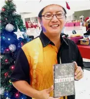  ??  ?? Belud ballads: Ewon showing the Christmas album that features both Kadazandus­un and Bahasa Malaysia Yuletide songs.