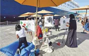  ?? Ahmed Ramzan/Gulf News ?? Artists at the National Day Art Festival yesterday at the Queen Elizabeth 2. Organised by ZeeArts, the festival that celebrates National Day with live paintings was launched in 2011.