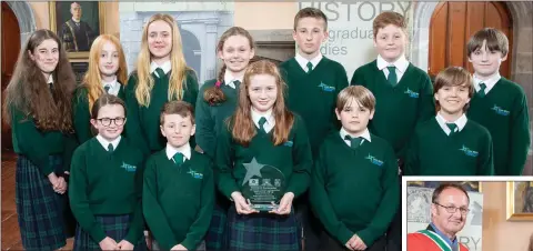  ??  ?? Sixth class pupils from St Brigid’s NS in Greystones with their award, which was presented to them by Professor David Ryan, Head of the School of History at UCC (left).