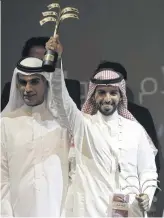  ??  ?? Saudi producer Abdulaziz al-Shalahei waves his award.