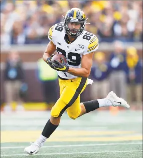  ?? Paul Sancya / Associated Press ?? Iowa wide receiver Nico Ragaini, a former standout at Notre Dame-West Haven, runs after a catch during the second half against Michigan in Ann Arbor in October.