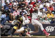  ?? MORRY GASH — THE ASSOCIATED PRESS ?? The Philadelph­ia Phillies’ Bryce Harper hits a two-run home run during the first inning of a baseball game against the Milwaukee Brewers Monday in Milwaukee.