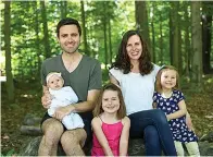  ?? Associated Press ?? ■ Tyler Moore, his wife, Emily, and daughters Mabel, 5, center, Matilda, 3, and Margaret, 3 months. Tyler Moore, a teacher, said working from home while helping to care for the house and his children has sometimes left him frustrated that he’s not doing any one thing well.