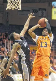  ?? JASON MALLOY/THE GUARDIAN ?? Island Storm forward Du’Vaughn Maxwell takes a shot over Moncton Magic forward Brent Jennings Tuesday at the Eastlink Centre.