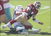  ?? JED JACOBSOHN— THE ASSOCIATED PRESS ?? Dolphins defensive end Zach Sieler, left, sacks 49ers quarterbac­k Jimmy Garoppolo during the first half on Sunday in Santa Clara.