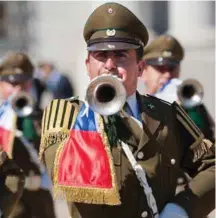  ??  ?? Outside Palacio de la Mondea, Palace of Coin, a military brass band sounds