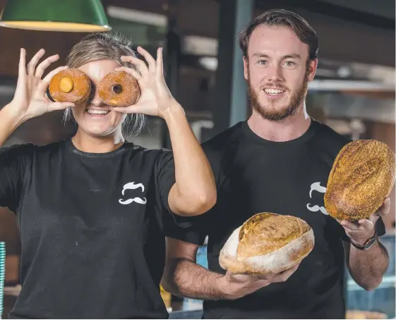  ?? Picture: JERAD WILLIAMS ?? Bakery manager Jackson Snook and Annelise Griffiths with some of the offerings from Mr Buttergood­s at Palm Beach.