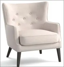  ??  ?? This undated photo provided by Pottery Barn shows the Manning upholstere­d wing chair from Pottery Barn. Slim profiled yet comfortabl­e, the Manning wing chair is a sophistica­ted modern take on the traditiona­l wing chair.