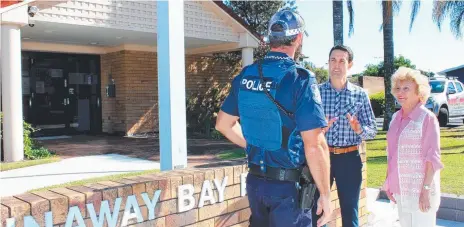  ??  ?? LNP State election candidate David Crisafulli and resident Betty Robinson talk to a police officer at the Runaway Bay Police Station.