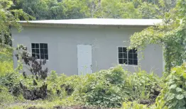  ?? ?? One of the completed board structures in the commune in Bell Hill, St Mary, where the Following the Blueprint Ministries members are retreating to embrace the concept of country living in anticipati­on of end times.