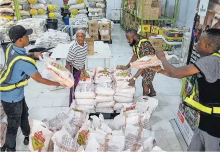  ?? Picture: REUTERS ?? Volunteers arrange food supplies inside the Lagos Food Bank warehouse in Lagos, Nigeria on March 23, 2024.