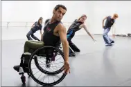  ?? ?? AXIS Dance Company member JanpiStar, who has been a paraplegic since he was a year old following an auto accident, practices with others for their opening ceremony show.