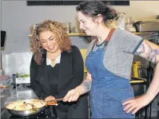  ?? COLIN MACLEAN/JOURNAL PIONEER ?? Chef Megan Beairsto, right, invites chef Ilona Daniel into her kitchen at Open Eats restaurant in Summerside, where they cook up some Seafood Hodgepodge.