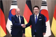  ?? Photo via AP) ?? German Chancellor Olaf Scholz, left, and South Korea’s President Yoon Suk Yeol shake hands before their meeting at the Presidenti­al Office in Seoul, South Korea Sunday, May 21, 2023. Scholz arrived in Seoul on Sunday for the summit with Yoon after attending the G7 summit in Hiroshima, Japan. (Chung SungJun/Pool