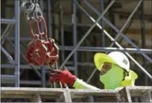  ?? ALAN DIAZ — THE ASSOCIATED PRESS ?? A constructi­on worker continues work on a condominiu­m project in Coral Gables, Fla. On Friday the Labor Department released the U.S. jobs report for June.