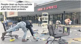  ??  ?? People clean up items outside a grocery store in Chicago after the latest protests