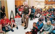  ?? BY NATE BILLINGS, THE OKLAHOMAN] [PHOTO ?? Teachers and protesters for increased education funding outside the state House of Representa­tives chamber on the fourth floor Tuesday during the second day of a walkout by Oklahoma teachers at the state Capitol.