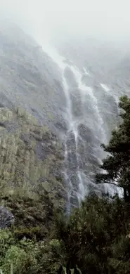  ?? ?? Below left: Enjoying the spectacula­r view before dropping down to Lake Mackenzie. Below right: The Earland Falls featured on the last day of the Routeburn.
Opposite page: The verdant valley below Falls Hut.