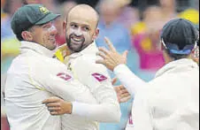  ?? AFP ?? Nathan Lyon (centre) celebrates with teammates after dismissing Alastair Cook on the fourth day of the final Ashes Test.