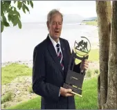 ??  ?? Micheál Ó Muircheart­aigh celebrates winning the Lóchrann prize