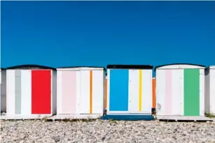  ?? ?? Bright beach huts on Le Havre’s pebb l e beach (Getty/iStock)