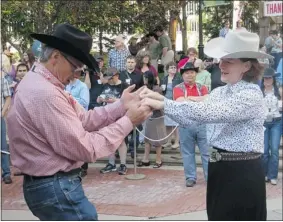  ?? Canadian Press ?? Alberta Premier Alison Redford dances the two-step with former Stampede president
Dr. David Chalack at a Calgary Stampede breakfast event on Monday.