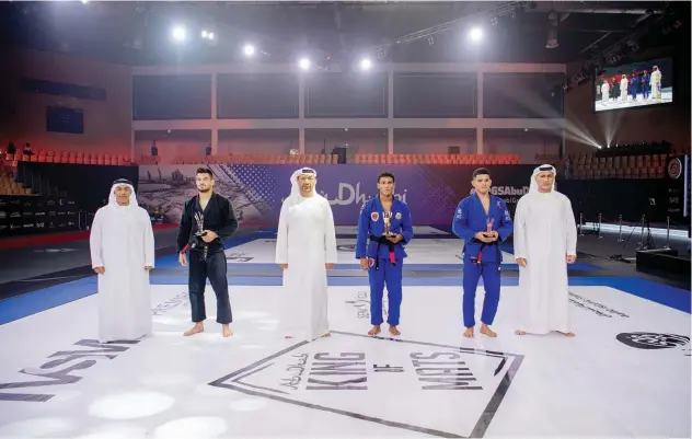  ?? ?? ↑
Meyran Alves (centre) poses with the trophy after winning the King of Mats title at the Abu Dhabi Grand Slam World Tour finale.