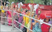  ?? NITIN KANOTRA / HT ?? ■ Pilgrims shows their registrati­on cards at a base camp after the pilgrimage was suspended in Jammu on Friday.