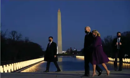  ??  ?? The Bidens at a Covid memorial at the Lincoln Memorial on 19 January. Photograph: Evan Vucci/AP