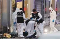  ?? ?? Police members work near the bodies of unidentifi­ed people after an explosion on busy pedestrian Istiklal street in Istanbul yesterday.