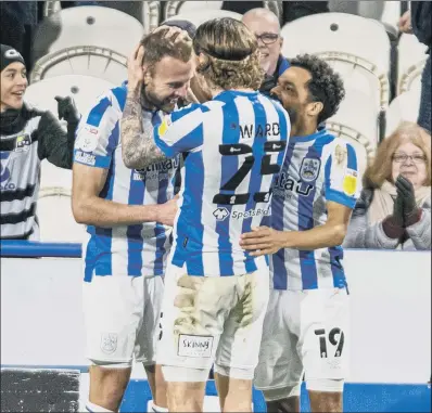  ?? PICTURE: TONY JOHNSON ?? BACK AMONG THE GOALS: Jordan Rhodes, left, is congratula­ted by team-mates after his first goal for 3,448 days in a Huddersfie­ld Town shirt sent the Terriers up to fifth in the Championsh­ip table.