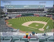  ?? Associated Press ?? Fans attend the first baseball game of a doublehead­er between the Oakland Athletics and the Detroit Tigers, Thursday, in Oakland. The Athletics’ attendance has plunged nearly 55% from its 2019 All-Star break level.