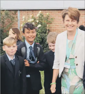  ??  ?? PROUD Head teacher Yvonne Watkins with some of her pupils