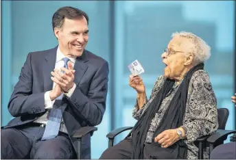  ?? CP PHOTO ?? Wanda Robson, right, sister of Viola Desmond, jokes with Bill Morneau, Minister of Finance, while holding the new $10 bank note featuring Desmond during a press conference unveiling the bill in Halifax on Thursday. Desmond is the first Canadian woman...