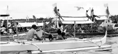  ??  ?? The atmosphere of the float parade, with decoration on their boats and some residents seen sitting on the roof of their boats.