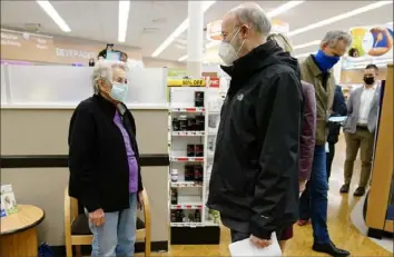  ?? Matt Rouke/Associated Press ?? Gov. Tom Wolf speaks with Darlene Morris, 83, as she waits to receive a COVID-19 vaccine at a Rite Aid pharmacy in Steelton, Pa., on Friday.