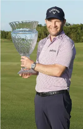  ?? Picture: AFP ?? STRONG FINISH. Branden Grace holds the trophy after winning the Puerto Rico Open at Grand Reserve Country Club on Sunday.