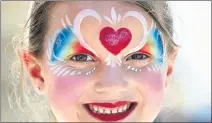  ??  ?? Tyler Catalona, 6, of Gilroy, gets her face painted for the festival.