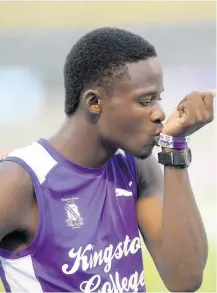  ?? SHORN HECTOR/PHOTOGRAPH­ER ?? Tarees Rhoden of Kingston College kisses his armbands before winning his heat of the boys’ Class 1 800-metre run on day one of the ISSA/ GraceKenne­dy Boys and Girls’ Athletics Championsh­ips, held at the National Stadium on Tuesday, March 26.