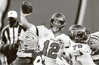  ?? Jason Behnken / Associated Press ?? Buccaneers quarterbac­k Tom Brady was 17 of 27 for 166 yards and two TDs against the Packers on Sunday at Tampa, Fla. Brady is 2-1 in three career starts against Green Bay’s Aaron Rodgers.
