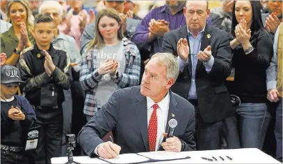  ?? Rick Bowmer ?? The Associated Press Interior Secretary Ryan Zinke signs an order after announcing a wildlife initiative earlier this month in Salt Lake City. Zinke is overseeing a sweeping reorganiza­tion of the Interior Department.