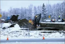  ?? DAN JOLING — THE ASSOCIATED PRESS ?? A dump truck and excavator work on a temporary fix of an off ramp that collapsed after an earthquake on Friday in Anchorage, Alaska. A driver attempting to exit Minnesota Drive at Internatio­nal Airport Road was not injured when the ramp sank. Two strong earthquake­s measuring 7.0 and 5.7 ripped apart highways, cracked buildings and rattled people’s nerves around Anchorage.