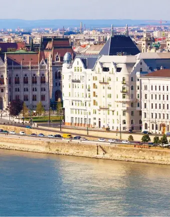  ??  ?? Blue Danube: Passing between Buda and Pest is something that can only be done on a river cruise, left; enjoying an unforgetta­ble view of the Hungarian capital on deck, right