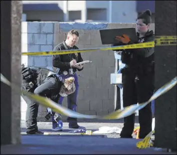  ?? Erik Verduzco Las Vegas Review-Journal @Erik_Verduzco ?? Police investigat­e a homicide Saturday on Twain Avenue. “We had a lot of gunshot rounds that were fired here,” Metropolit­an Police Department Lt. Ray Spencer said.