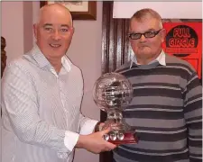  ??  ?? Liam McCormack receives the Hall of Fame award on behalf of his dad Tom from Gussie Carroll.