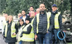  ??  ?? Co-op colleagues stand with rubbish from canal